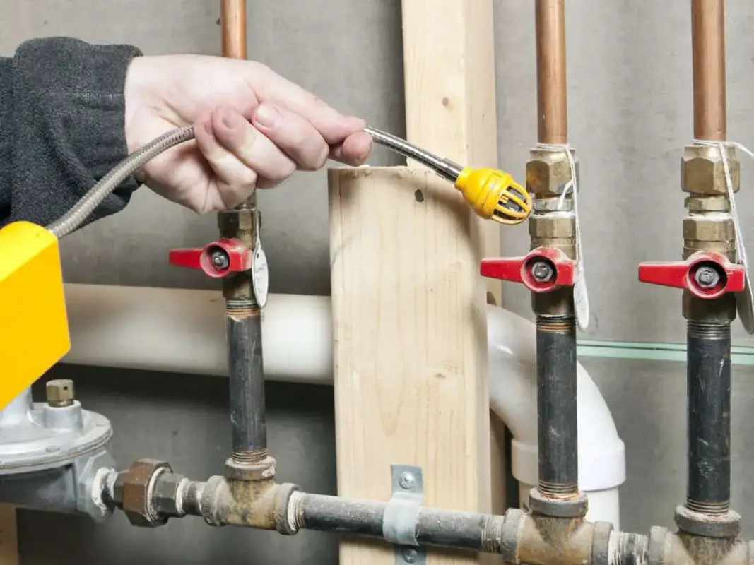 Licensed Albuquerque plumber inspecting gas line installation