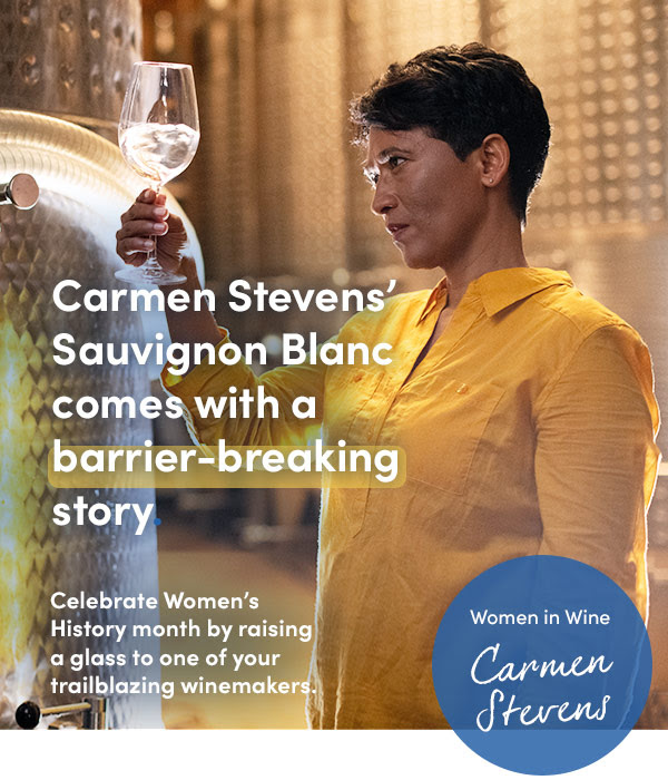 Carmen analyzing her wine looking happy