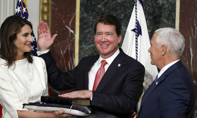 Vice President Mike Pence, right, swears in William F. Hagerty, to be U.S. Ambassador to Japan, as his wife Chrissy Hagerty holds the Bible, in the White House complex in July 27, 2017