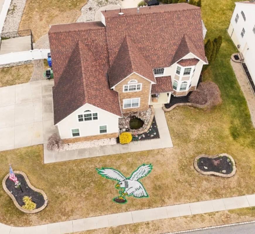 A custom Philadelphia Eagles logo painted on a lawn.