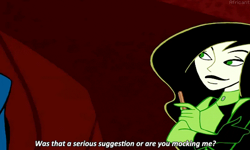 An animated GIF of Dr. Drakken giving Shego the stink eye while she smirks. He asks her 'Was that a serious suggestion, or are you mocking me?'