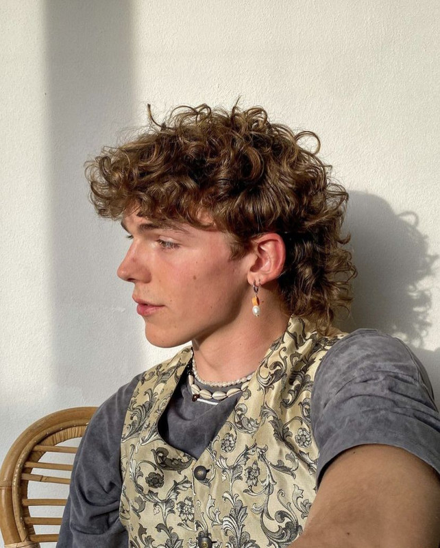 Image of man with shaggier version of Dennis’s S2 haircut