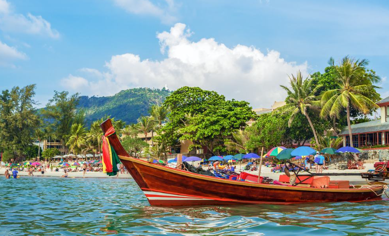 Kata beach in Phuket with Thai traditional boat on shore
