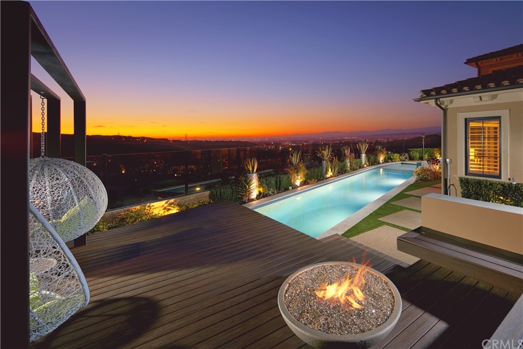 Night view of pool and city lights at 107 Misty Sky, Irvine, California
