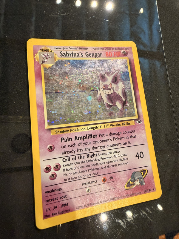 damaged Pokémon card before cleaning and restoration showing holo micro-scratches