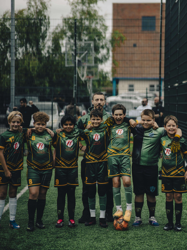 Constantine Football Club squad celebrating with trophies after winning a youth football tournament