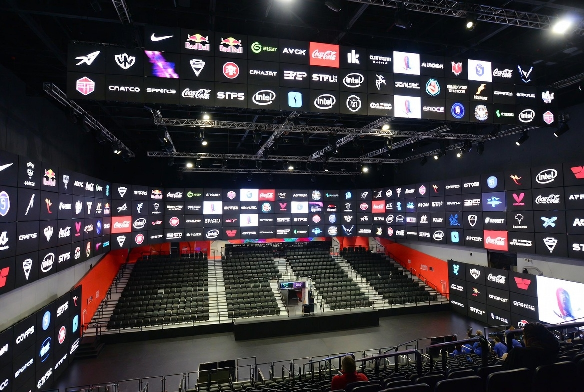 Esports arena showing various sponsor logos and brand partnerships displayed prominently
