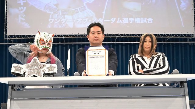 Photo of Taro Okada presenting the signed contract for the Wonder Of Stardom title match between Starlight Kid and Konami.