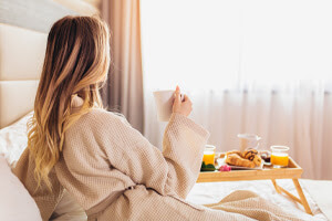 Guest in bed looking out window