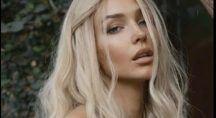 A Naked Brown-haired Girl Sitting With Her Breasts Exposed While Stuff Is Coming Out Of Her Mouth.