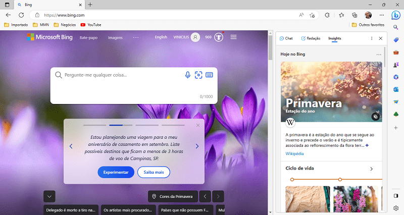 A imagem é um print do navegador Microsoft Edge aberto na página inicial do Bing. Nela mostra ao fundo flores na cor lilás representando cores da primavera. Mostra também uma barra lateral com as novas funcionalidades do Bing Chat com Inteligência Artificial.
