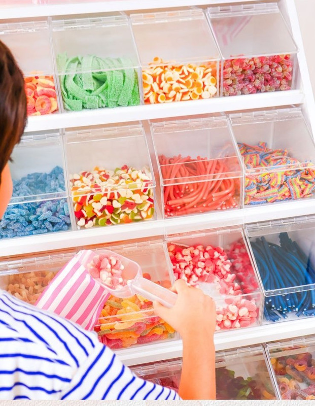 Child enjoying the pick and mix experience at Sweet Spot candy stand