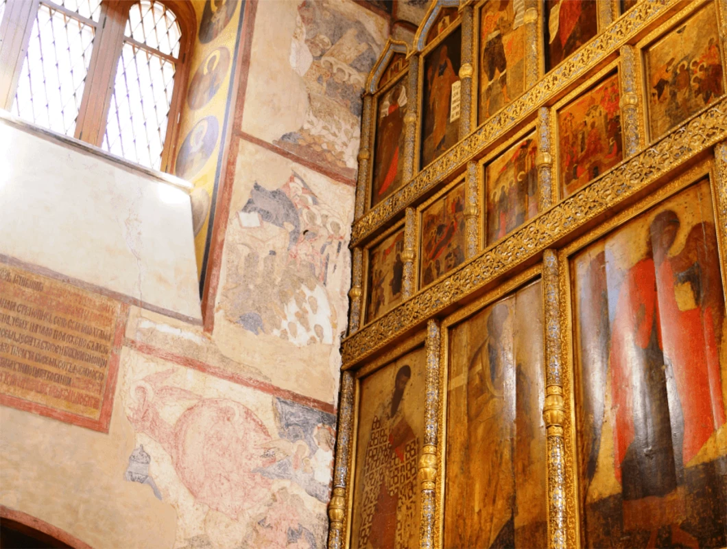 Ornate gilded interior with icons and frescoes inside a Kremlin cathedral or palace