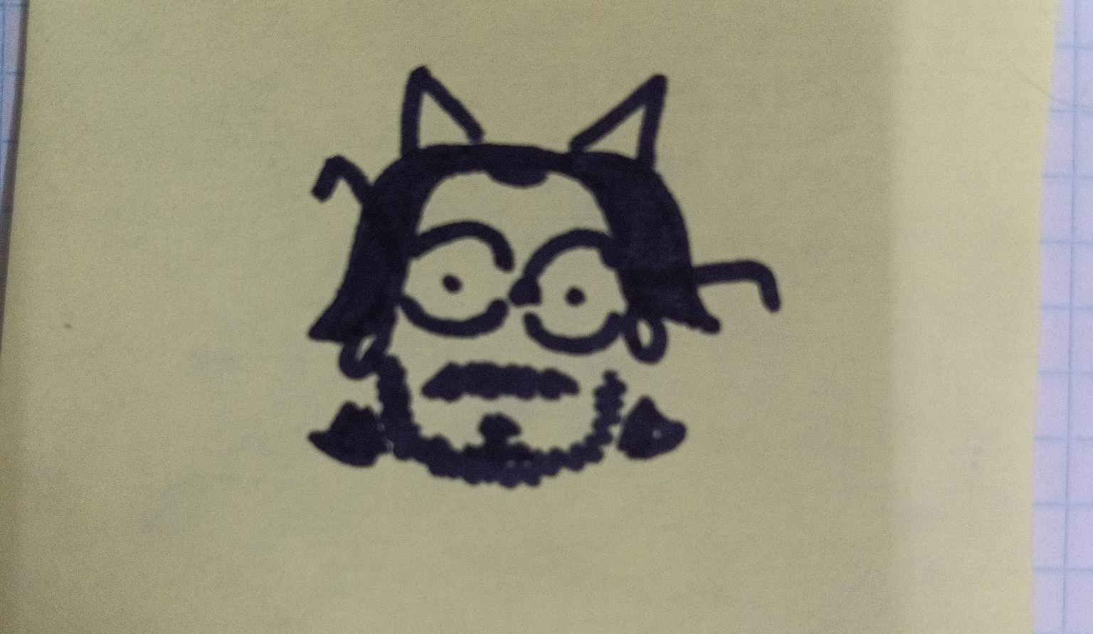 sharpie doodle of a bespectacled balding guy with a beard and triangles coming from his head that could be horns or cat ears