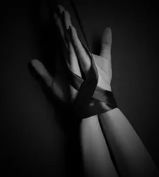 stock-photo-cropped-view-female-hand-tied-satin-red-ribbon-black-background-ezgif-com-effects.webp