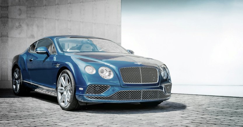 blue luxury coupe illustrating a high-mileage luxury vehicle purchase decision