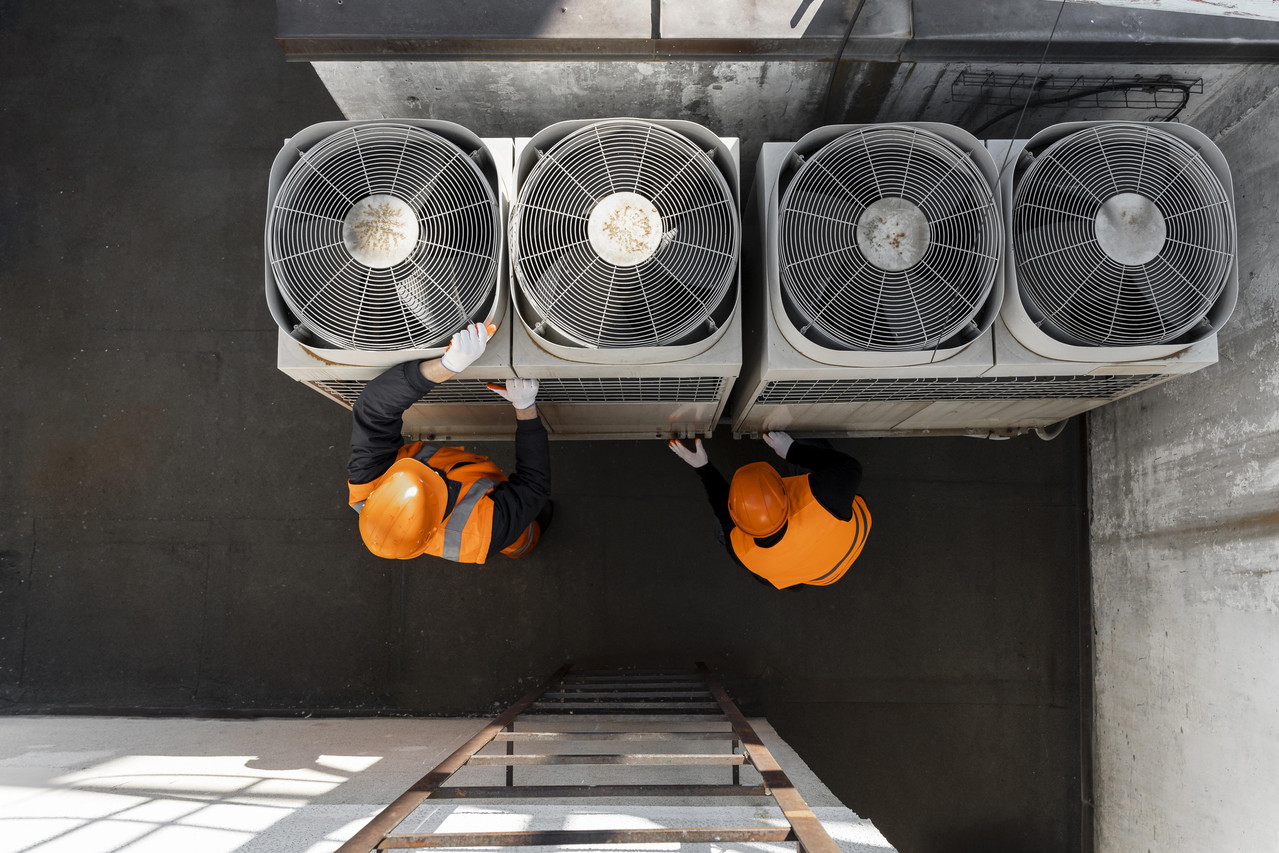 HVAC Technician working on AC unit