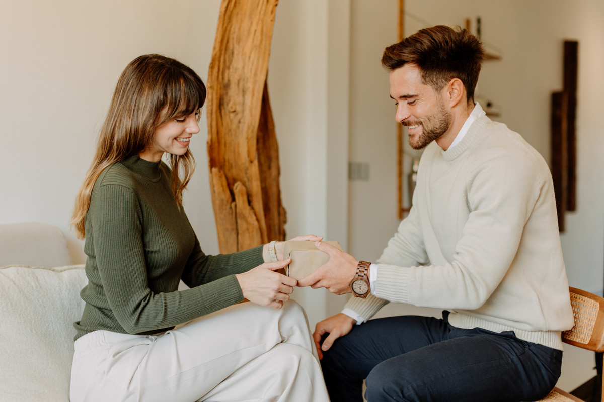 Couple-celebrating-first-anniversary-with-personalized-wooden-watch-gifts