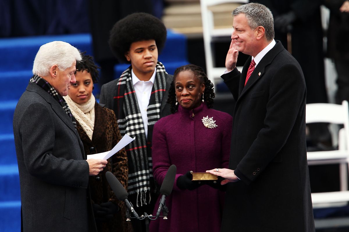 Former President Bill Clinton administers the oath of office at City Hall to Bill de Blasio