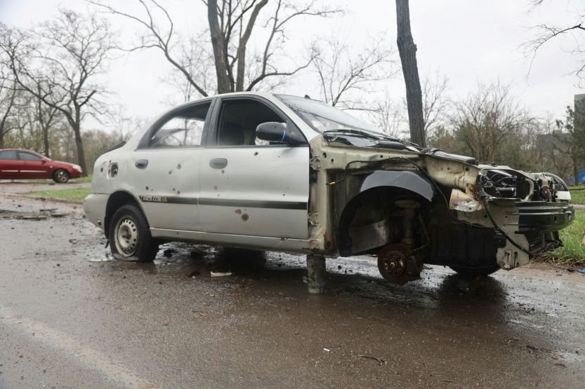 severely damaged sedan with major front-end and structural damage