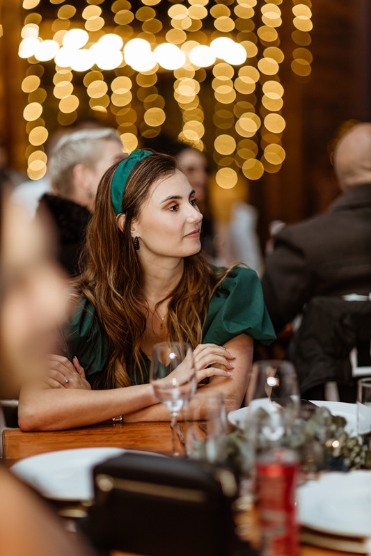 A bride and groom walking away from the chapel.