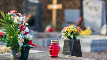 cemetery with vases and flowers on headstones