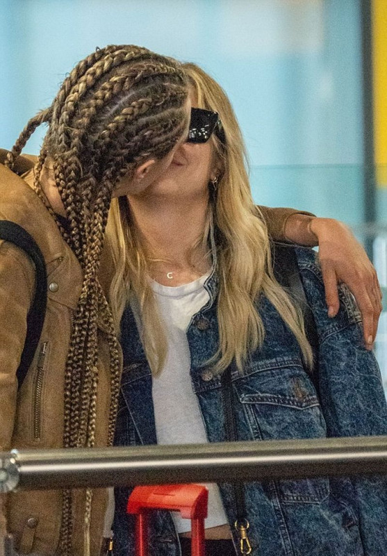 cara-delevingne-and-ashley-benson-at-heathrow-airport-in-london-