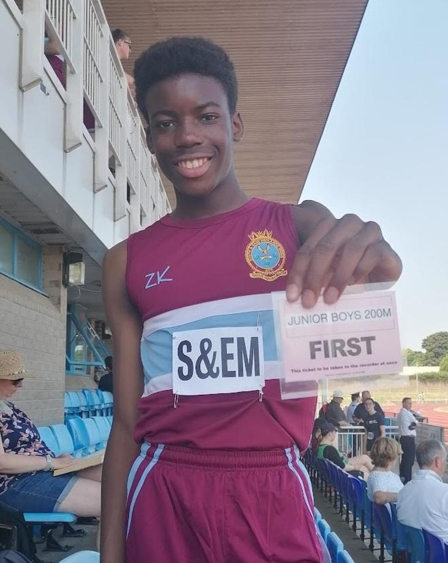 A 13-year-old Gabriel Oguagwu smiling and holding a first-place card