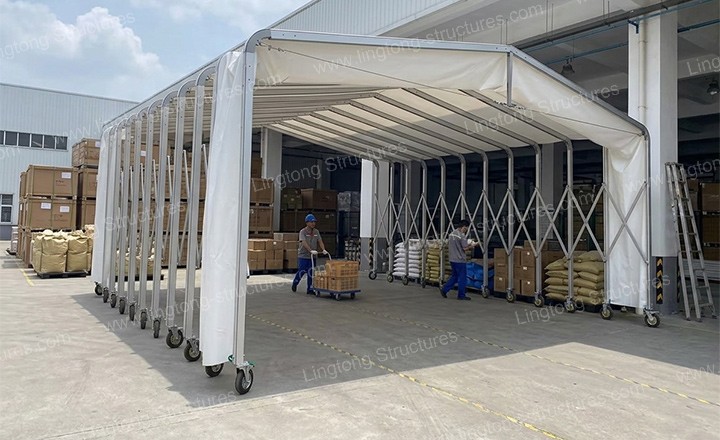 Retractable tunnel tent extended for factory loading bay canopy providing weather protection