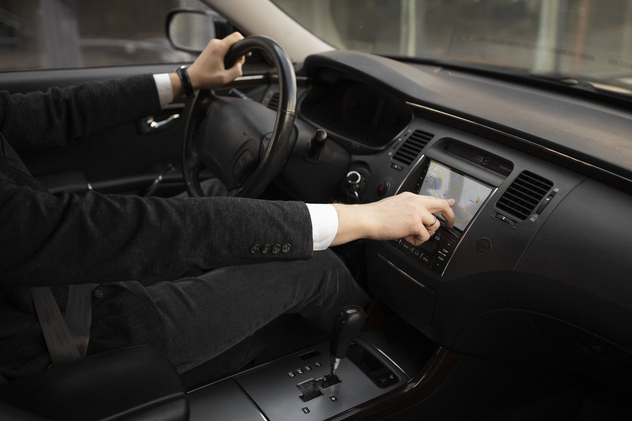 man using his car s options while driving (1)