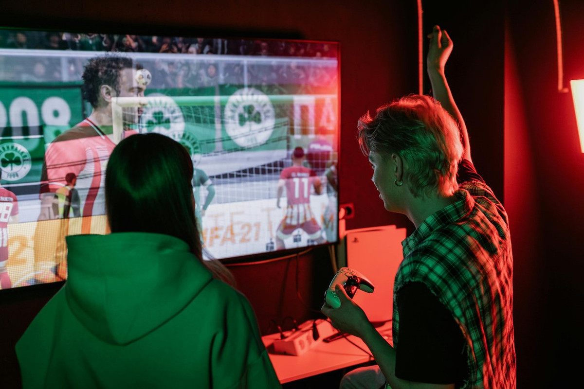 A Man and Woman Playing Football Video Game