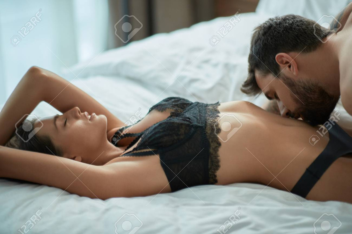 113488134-young-passionate-man-and-female-making-love-in-bed