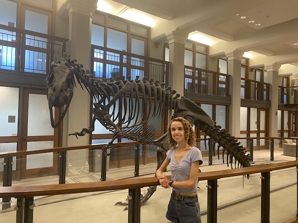 Author standing in front of dinosaur skeleton in Guyot Hall