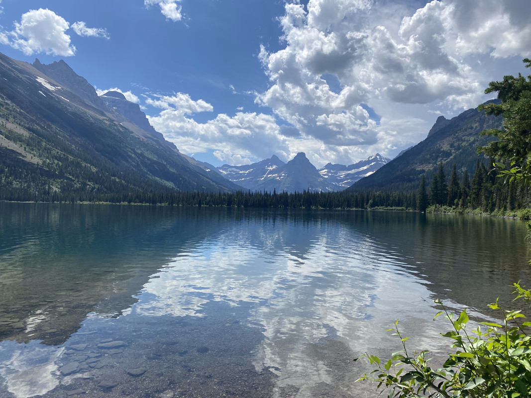Lake with sky and mountains behind it