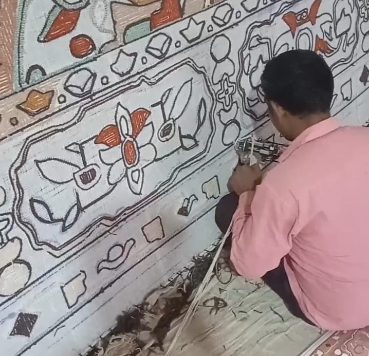 Artisan hand-knotting a premium Bhadohi carpet