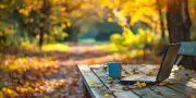 pngtree-laptop-and-coffee-mug-on-a-wooden-table-surrounded-by-autumn-image-17621232