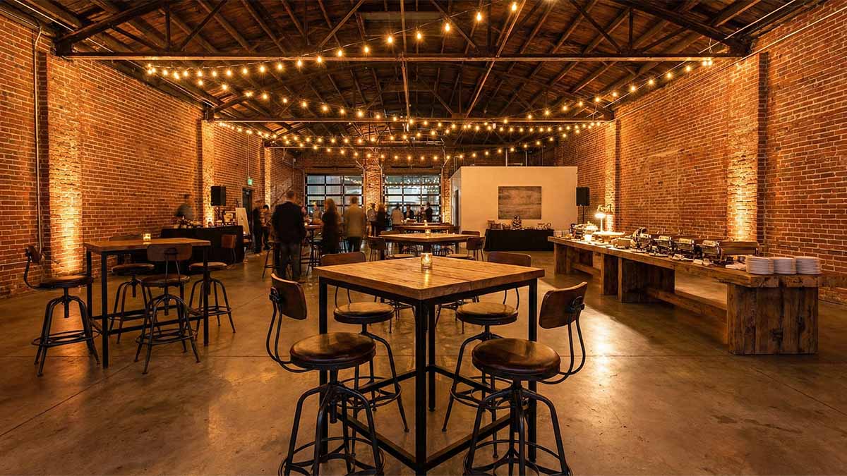 Мебель в стиле лофт: высокие столы, металл и дерево в интерьере с кирпичной кладкой