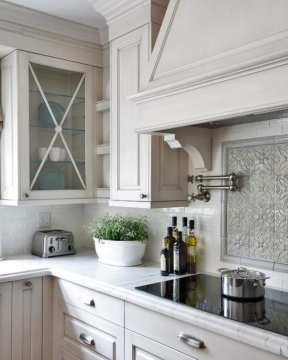 grey-mosaic-cooktop-backsplash-glass-front-kitchen-cabinets-with-x-trim.jpg
