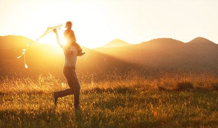 74137512-happy-father-s-day-child-girl-and-dad-with-a-kite-on-nature-in-summer.jpg