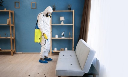 Technician treating the source of a pest problem at a Baltimore home