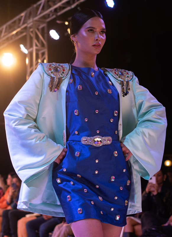 Aqua green blazer with rhinestone embellishments on the shoulders and decorative buttons.
