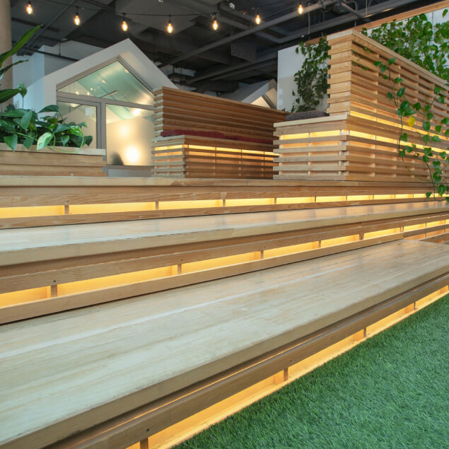 Tiered lounge area with lots of greenspace and lighting