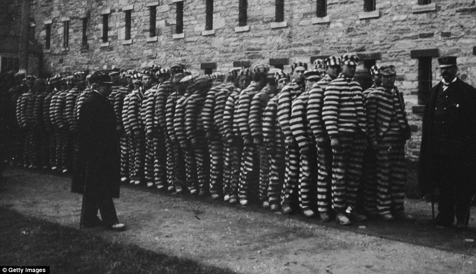 A-group-of-prisoners-in-striped-suits-and-hats-at-The-Lock-step.jpg