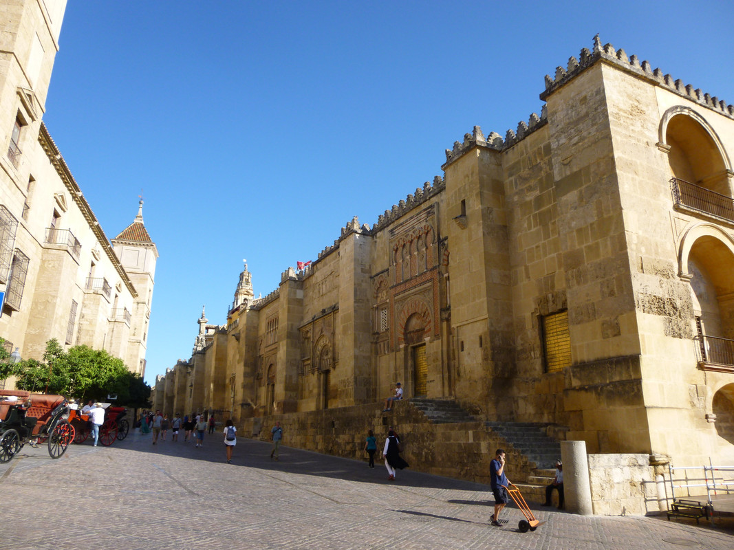 On the left hand side is another very pretty building with regular towers.  I think it is a more modern construction.  On the right hand side is the golden stone of the outside of the Mezquita.  It is very square with regular crenulations.  On the outside, you can see what were the entrance of the mosque.