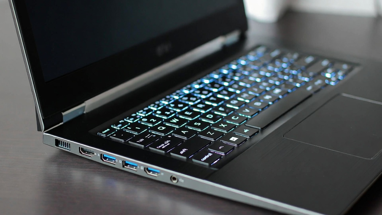 Close up of a new laptop with glowing backlit keyboard and modern ports