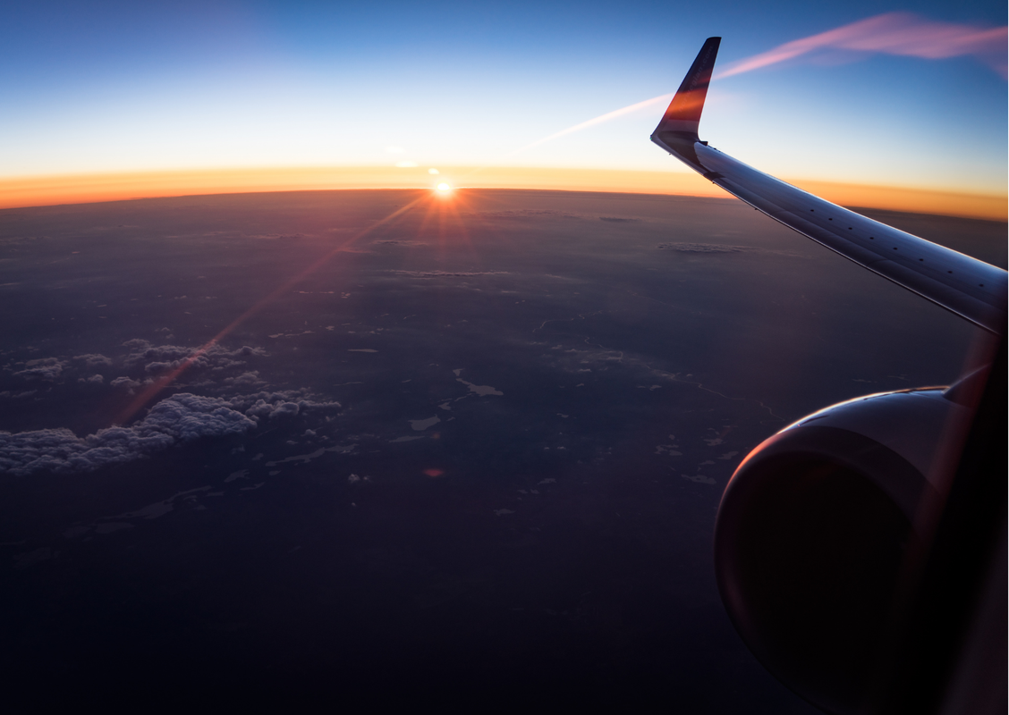 Delta aircraft at a U.S. airport gate at dusk