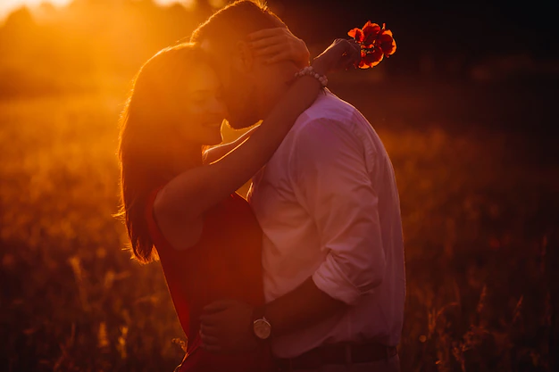 handsome-bearded-man-hugs-woman-red-dress-tender-standing-golden-summer-field-8353-8643.webp