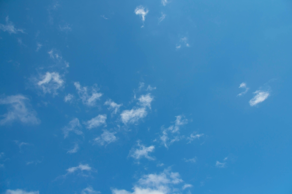 Vast blue sky with scattered clouds in the background
