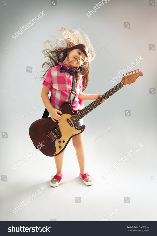 stock-photo-beautiful-artistic-little-girl-playing-guitar-on-gre