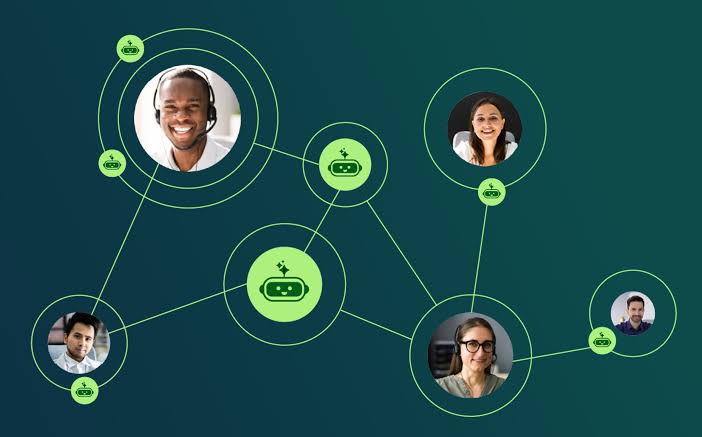 A bald man in a black suit with a red tie, looking serious, with a background of hanging knives.